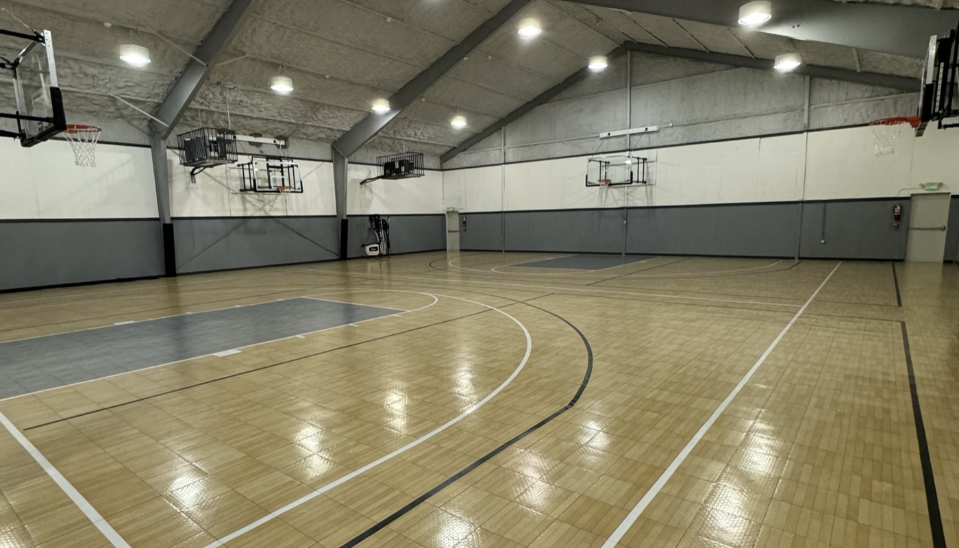 Wide interior view of the Liberty Hill Athletics indoor basketball court